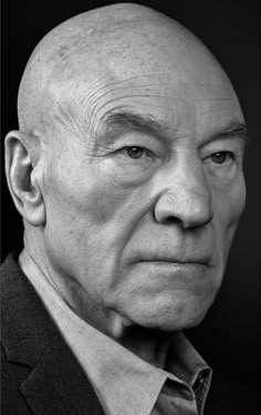 black and white photograph of an older man with bald hair looking to his left side