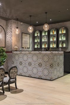 the bar is decorated with black and white tiles, which are embellished in intricate designs