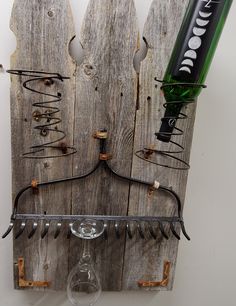 a wine glass holder made out of old wooden boards with wire and bottles attached to it