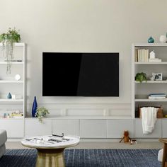 a large flat screen tv mounted on the side of a wall in a living room