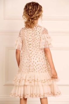 Description & Details The Autumn Leaves Kids Dress in Cream / Caramel. This dress is embellished with a glittering leaf motif that disperses down the body of the dress and delicately adorns the frills, creating reminiscent of autumn falling leaves. Beautifully designed in soft tulle, gently gathered tiers at the sleeves and skirt hem create the prettiest, most whimsical style. Crafted with signature Needle & Thread frills adorn the neckline and shoulder. This magical piece will forever be a favo Festive Sequin Dress For Dress-up, Festive Embellished Dress-up Dresses, Glamorous Holiday Dress-up Dress, Glamorous Holiday Dress For Dress-up Occasions, Glamorous Dress For Dress-up And Holiday, Glamorous Holiday Dress, Festive Glamorous Ruffled Dress, Festive Short Sleeve Dress-up Dress, Festive Short Sleeve Dress