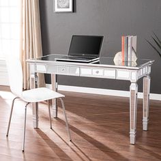 a white desk with a laptop on it