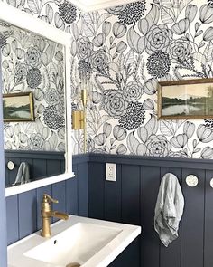 a white sink sitting under a bathroom mirror next to a wall mounted faucet