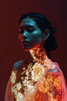 a woman in a white dress with flowers on her neck is illuminated by neon light