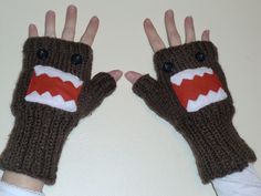 two hands with knitted mittens made to look like a monster's mouth