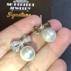 We are presenting you A PAIR OF matching SOUTH SEA PEARLS with LUSTROUS WHITE color. SET IN HANDCRAFTED, 18K SOLID GOLD DROP EARRINGS. ACCENTED WITH 64 E/VS, SPARKLING ROUND BRILLIANT DIAMONDS! IN CASE OF RETURN FOR US BUYERS. BUYERS MAY SEND THE ITEMS BACK TO OUR US-BASED OFFICE IN SALT LAKE CITY, UTAH ONLY ONE ITEM AVAILABLE!! NO DUPLICATES!! WHAT YOU SEE IN THE PICTURES IS WHAT YOU WILL GET SOLIDLY HANDCRAFTED EARRINGS! SUGGESTED RETAIL VALUE: $9,880 PEARLS: Size: 12 mm Shape: Oval/Round Colo Cubic Zirconia Round Pearl Earrings For Party, Elegant Pearl White Pearl Earrings For Party, Classic White Pearl Earrings For Party, White Cubic Zirconia Party Earrings, Diamond White Sterling Silver Party Bridal Earrings, Sterling Silver Bridal Earrings In Diamond White, Sterling Silver White Bridal Earrings For Party, Sterling Silver Bridal Earrings For Party, Elegant Diamond White Pearl Earrings For Party