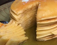 a stack of pancakes sitting on top of a green plate