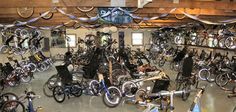 an indoor bike shop with many bikes and bicycles on the racks, hanging from ceiling