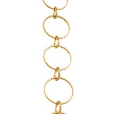 a gold chain bracelet with circles and links on the end, hanging from it's side