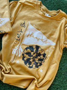 SJD | Youth Bella + Canvas Mustard PG Shirt Cheer Tshirt Designs, School Spirit Wear, Spirit Wear, School Spirit, Hawks, Bella Canvas, Mustard, Shirt Designs, Tshirt Designs