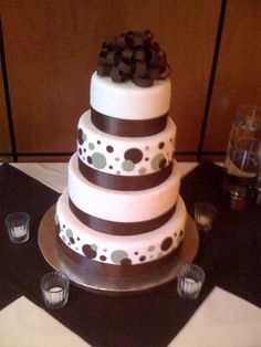 a three tiered cake with brown and white decorations