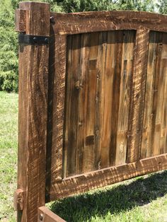 a close up of a wooden fence in the grass