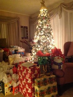 a christmas tree with presents in front of it