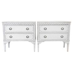 two white dressers with drawers on each side