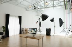 an empty room with several lighting equipment in it