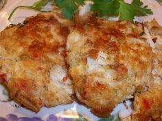 two pieces of chicken on a plate with parsley