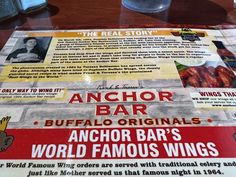 the menu for an anchor bar is displayed in front of a glass on a table