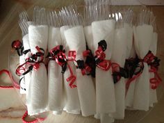 some white and red napkins are on a plastic plate with black ribbon around them