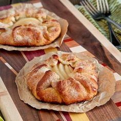 two pastries sitting on top of a wooden table