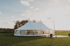 a large tent set up in the middle of a field