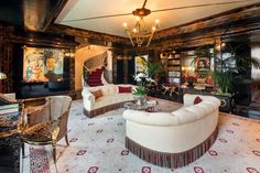 a living room with couches, chairs and a chandelier hanging from the ceiling