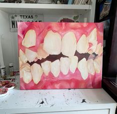 a painting of an open mouth is on display