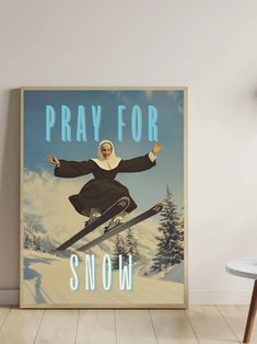 a poster with an image of a woman on skis in the snow, saying pray for snow