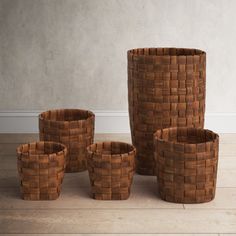 a group of brown baskets sitting on top of a wooden floor