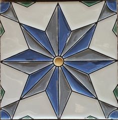 a blue and white tile design on the wall