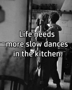 two people standing in a kitchen with the words life needs more slow dances in the kitchen