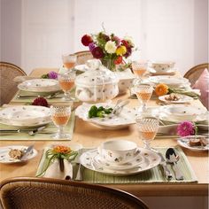 the table is set with dishes and cups