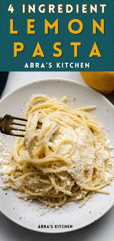 a white plate topped with pasta covered in parmesan cheese and lemon zest