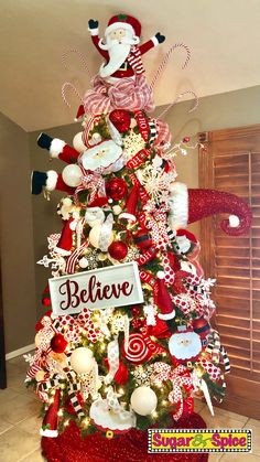 a christmas tree decorated with candy canes, santa clause and other holiday decor items