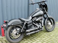 a black motorcycle parked next to a building