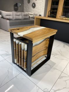 a wooden box with candles in it sitting on the floor next to a couch and coffee table