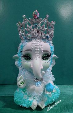 an elephant statue with a tiara on top of it's head and eyes