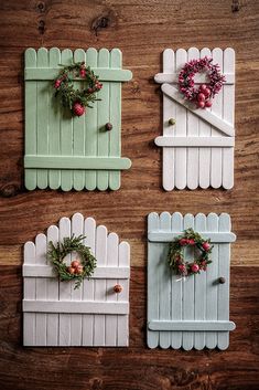 four pieces of white picket fence with wreaths on them