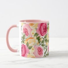 a coffee mug with pink and yellow roses on it