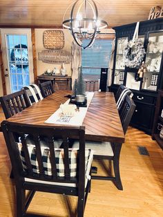 a dining room table with chairs and a chandelier