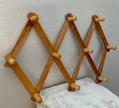 three wooden pegs are attached to the wall