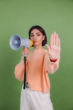 a woman holding a megaphone in her right hand