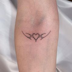 a tattoo on the leg of a woman with two birds in it's wings