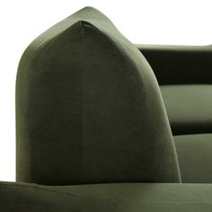 an upholstered green velvet chair with curved back and arms, viewed from the front