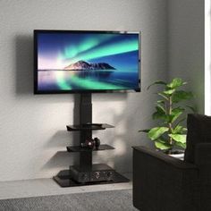 a flat screen tv sitting on top of a black stand