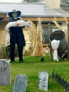 a cemetery with tombstones, headstones and scarecrows