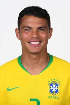 a soccer player is posing for a photo with the brazil national team uniform on his shirt