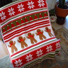 a knitted christmas blanket with teddy bears on it