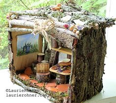 a doll house made out of tree trunks