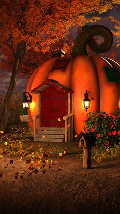 a house made out of pumpkins with lights on and flowers in the foreground