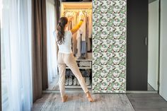 a woman standing in front of an open closet